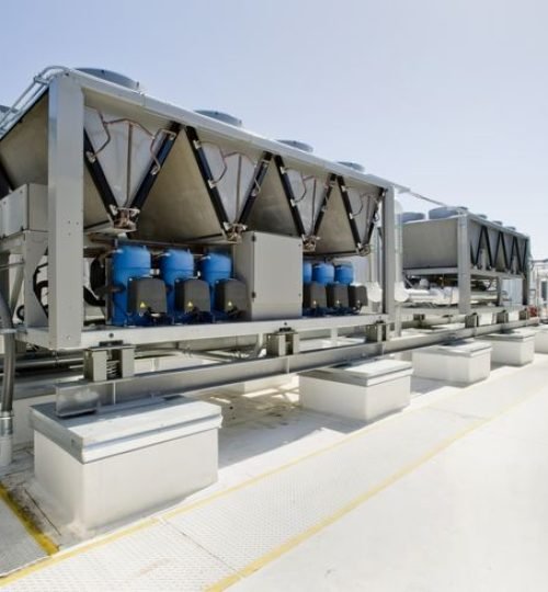 Rooftop cooling unit with chiller units and compressors.